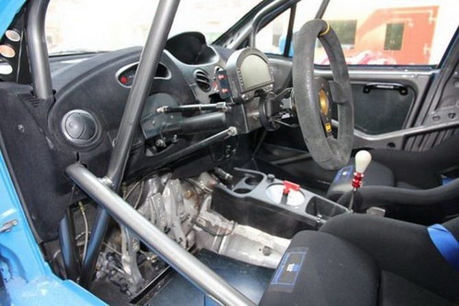 The interior has a FIA legal roll cage